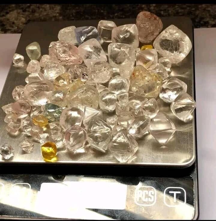 Rough diamonds being weighed on a scale