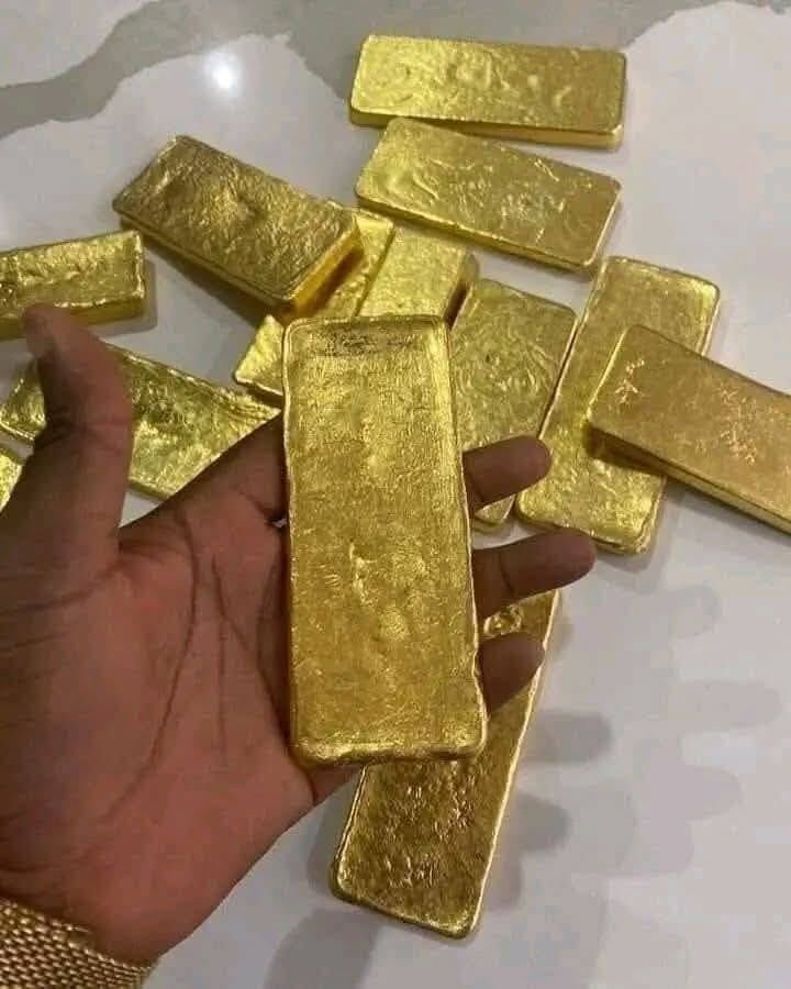 22K gold bar held in hand